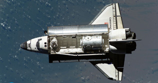 Shuttle steers closer to space station for hookup